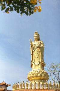 Low angle view of statue against sky