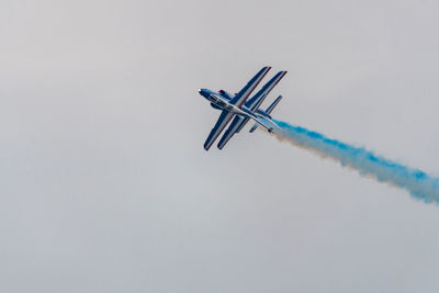 Low angle view of airplane flying against sky