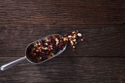 Variety of lentils in spoon on table