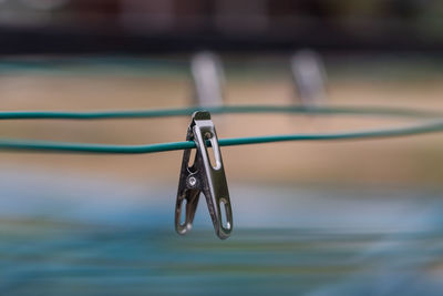 Close-up of water drop hanging on rope