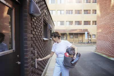 Smiling woman holding recycling