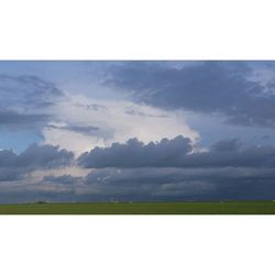 Scenic view of landscape against cloudy sky