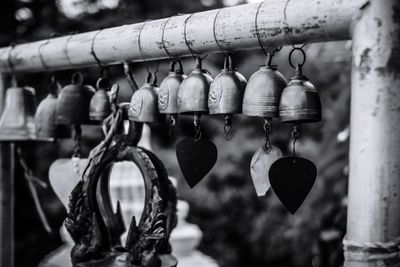 Close-up of padlocks hanging on railing