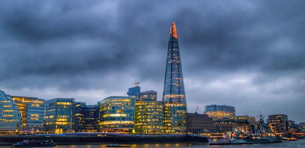 View of skyscrapers against cloudy sky