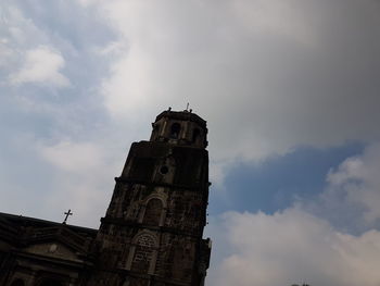 Low angle view of bell tower against sky