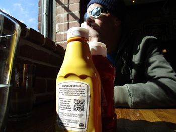 Midsection of man with beer bottles