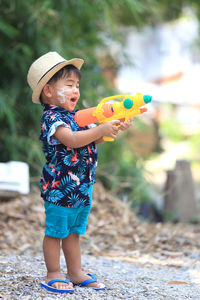 Full length of cute baby boy holding toy