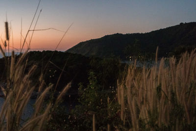 Scenic view of mountains against clear sky at sunset