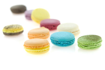 Close-up of multi colored candies against white background