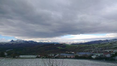 Scenic view of mountains against cloudy sky