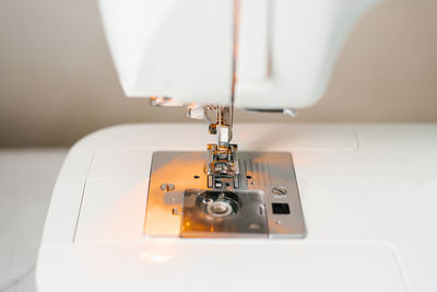 Close-up of a sewing machine with a needle and thread