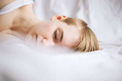 Young woman sleeping in bed