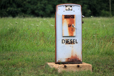 Abandoned fuel pump on grassy field