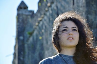 Low angle view of thoughtful woman by castle