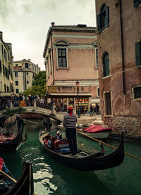 People on canal in city