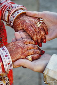 Cropped image of couple holding hands