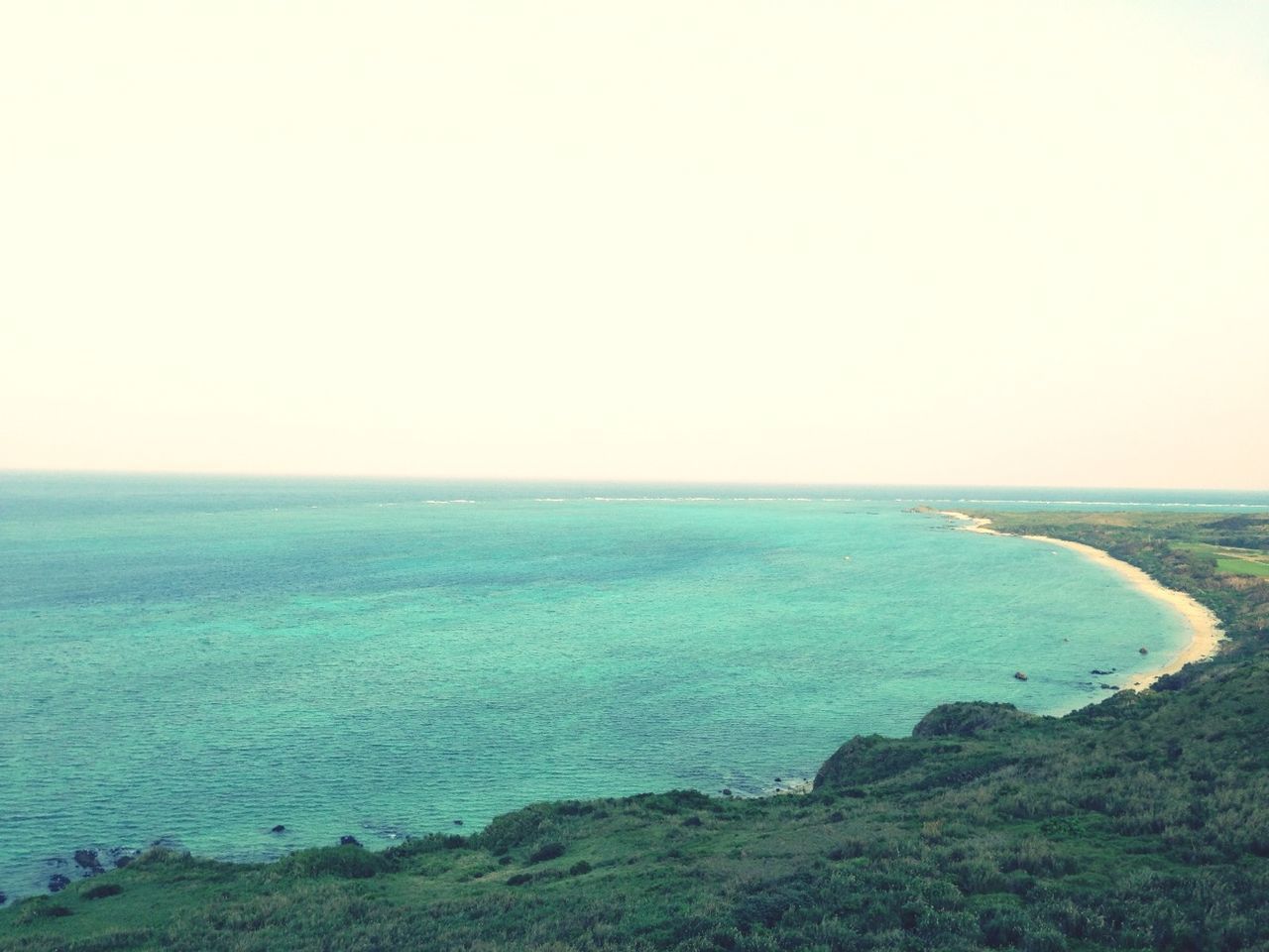 sea, horizon over water, water, tranquil scene, scenics, tranquility, beauty in nature, clear sky, copy space, nature, blue, idyllic, seascape, coastline, beach, shore, high angle view, non-urban scene, ocean, remote