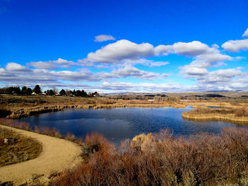 Scenic view of lake against cloudy sky
