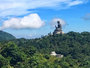 Statue of temple against cloudy sky