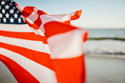 Close-up of flags against the sea