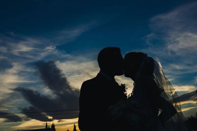 Man and woman standing against sky