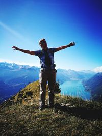 Full length of man standing on landscape against mountain range