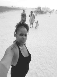 Portrait of woman standing at beach