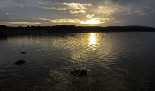 Scenic view of lake against sky during sunset