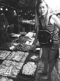 Woman standing at fish market