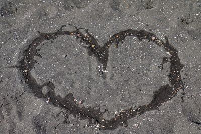 High angle view of heart shape on sand