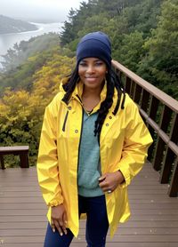 Portrait of young woman standing on footbridge