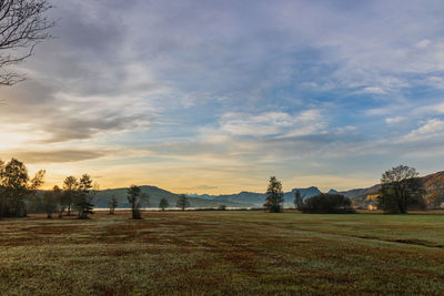 Scenic view of field against sky during sunset