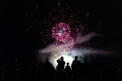 Low angle view of firework display at night