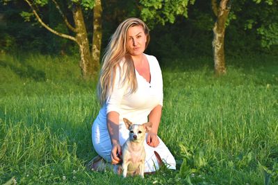 Woman with dog on field