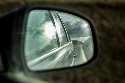 Close-up of side-view mirror of car