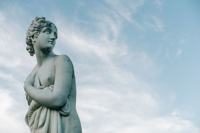 Low angle view of female statue against sky