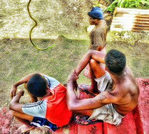 Rear view of couple sitting outdoors