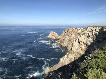 Rock formations in sea against sky