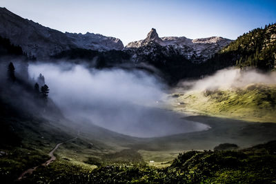 Scenic view of berchtesgaden alps against sky in foggy weather