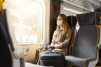 Full length of man sitting in train