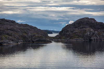Scenic view of river amidst mountains against sky