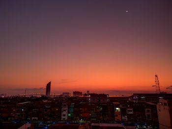 High angle view of illuminated buildings against sky at sunset