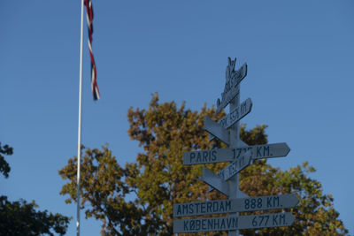 Low angle view of sign against sky