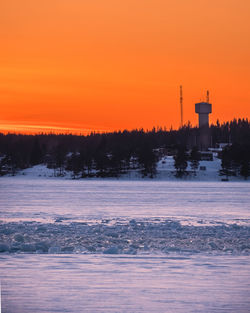 Scenic view of orange tower against sky during sunset