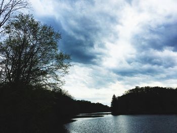 Scenic view of lake in forest against sky