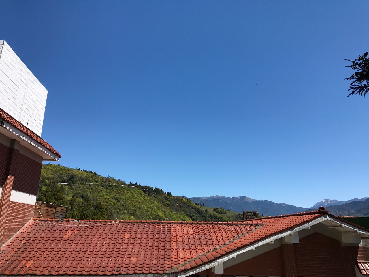 HOUSES AGAINST BLUE SKY