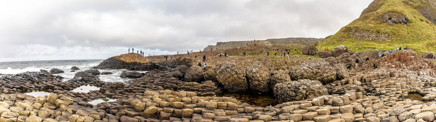 Panoramic view of rocks on beach against sky