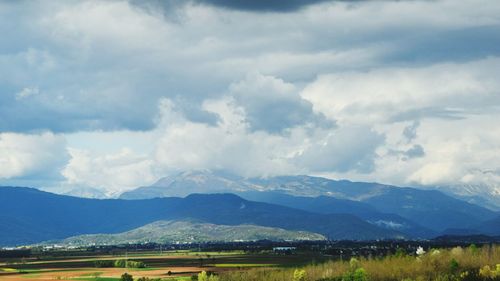 Scenic view of mountains against cloudy sky