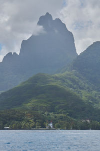 Scenic view of sea and mountains against sky