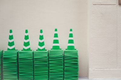 Close-up of green stack on white wall